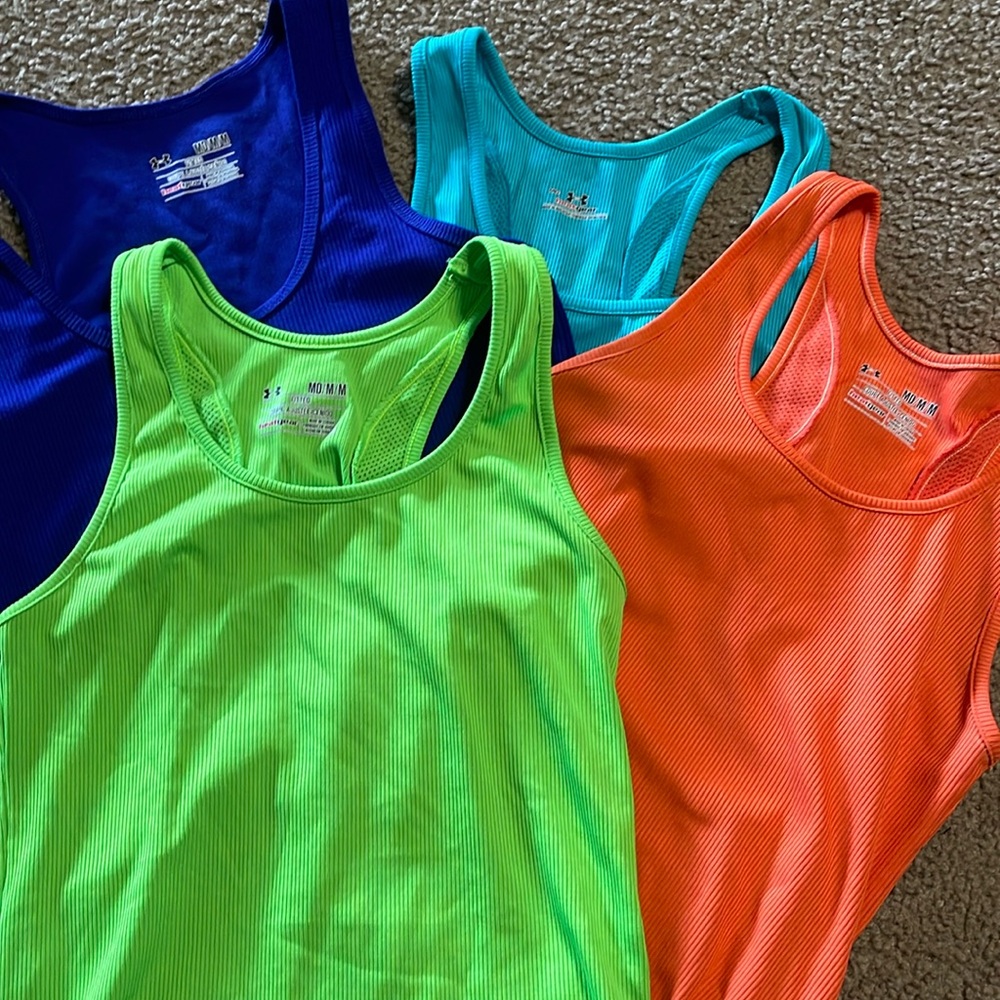 Four Under Armour tanks